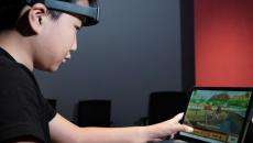 A child playing the new Cogo game while wearing the SenzeBand 2, an EEG headband by Neeuro