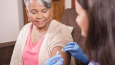 Nurse with a syringe and a patient