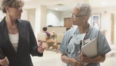 Business person and healthcare provider walking together