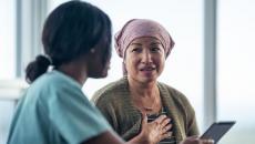 A woman with cancer is consulting her doctor. 