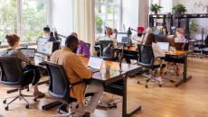 Employees sitting in an open working room 