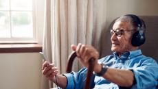 man in chair with cane 