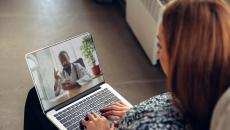 Person on a laptop speaking with a healthcare professional