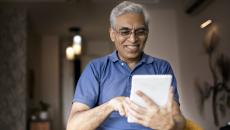 An elderly using a digital tablet