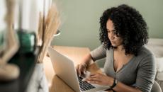 Person sitting at a desk looking at a computer