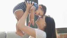 A young woman holding a baby.