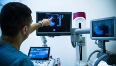 Radiologist examining a mammogram scan on a monitor