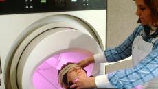 Technician prepares a patient for MRI