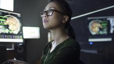 Person at a desk looking at a computer