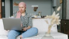 A cancer survivor using a laptop computer