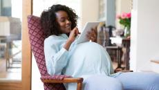 A pregnant woman using a tablet