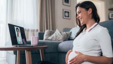 A pregnant person talks to a provider via telehealth