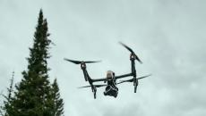 A drone flying over a forest area