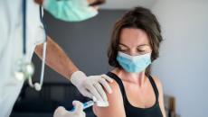 A woman receiving a vaccine.