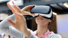 Person using a virtual reality headset while holding their hands up in front of them