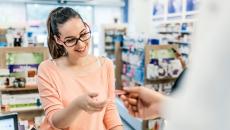 Person at a pharmacy interacting with a healthcare provider