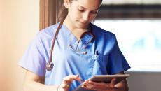 A doctor scrolling through a tablet