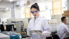 A lab researcher holding a digital tablet