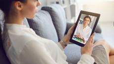 A woman talking to a provider on a tablet