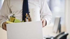 A worker holding a box of belongings.