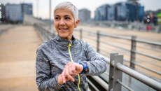 A person using a wearable while out on a run. 